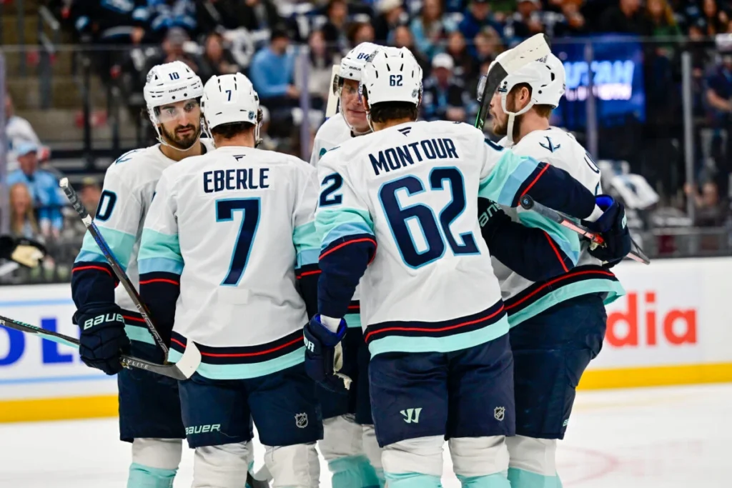 Eberle, Montour, teammates celebrate a goal in away jerseys.